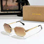 Gold-rimmed sunglasses with tan-tinted lenses and slim angular temples