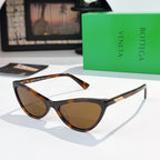 Cat-eye glasses with black frame and amber-brown tinted lenses