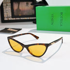 Cat-eye glasses with tortoiseshell frame and yellow tinted lenses