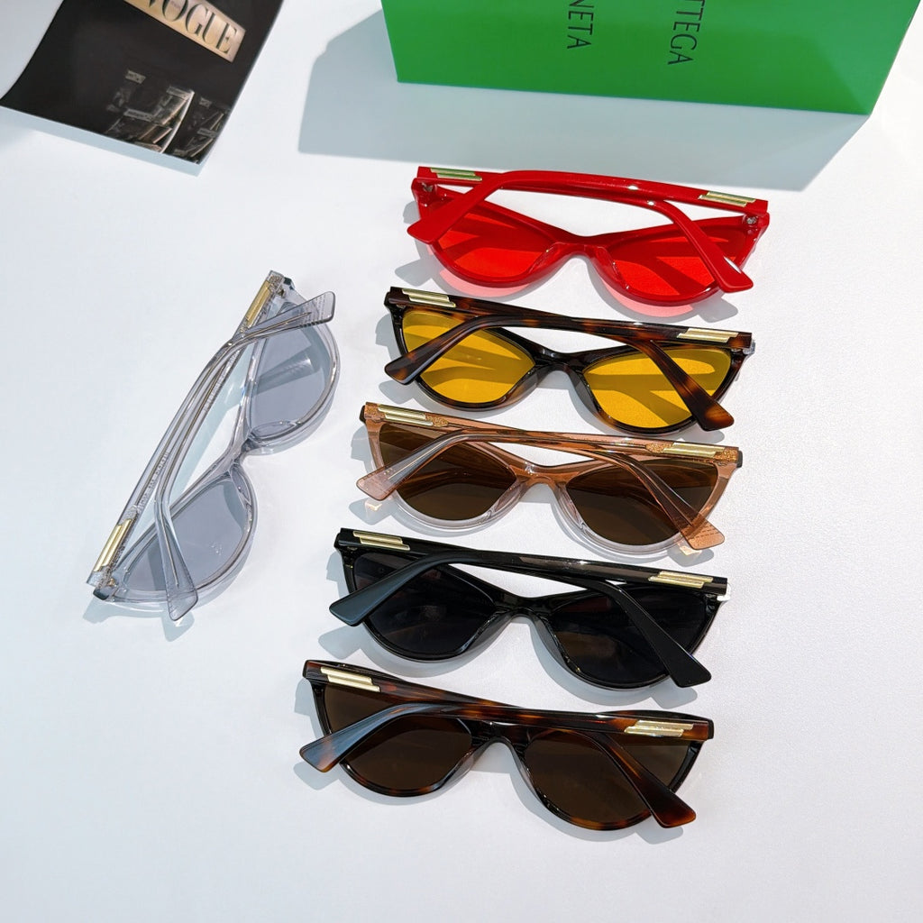 Set of cat-eye glasses in multiple colors, stacked with colored lenses