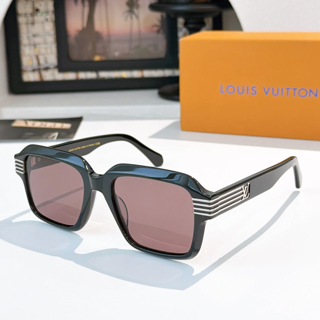 Designer sunglasses, dark frames with rose-tinted square lenses and gold striped temple accents.
