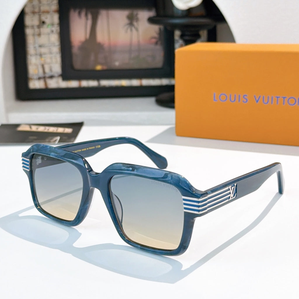 Designer sunglasses, blue square frames with light tinted lenses and gold striped temple detailing.
