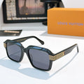 Designer sunglasses, dark teal square frames with smoky blue lenses and gold striped temple accents.