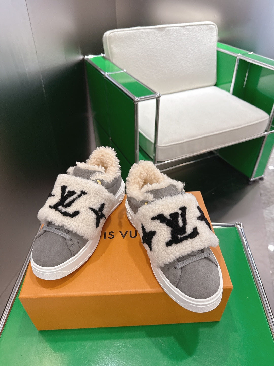 Gray low-top sneakers with cream sherpa cuffs and black logo print on sides