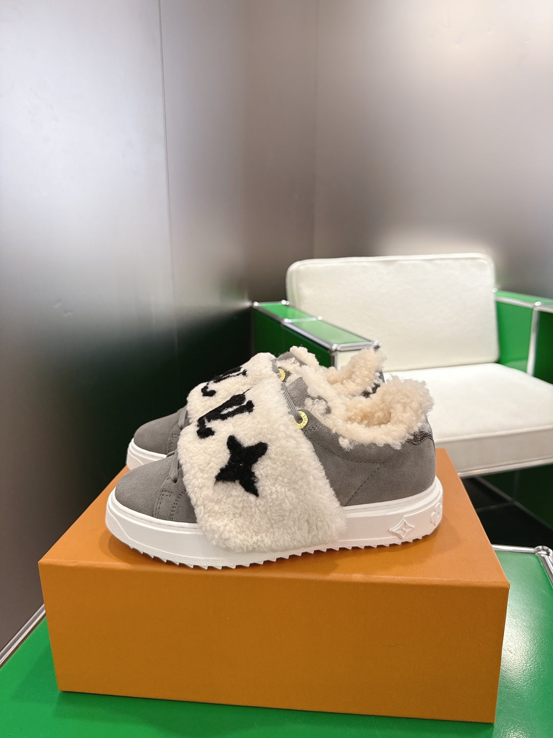 Gray slip-on sneakers with cream sherpa straps and black star logo detail