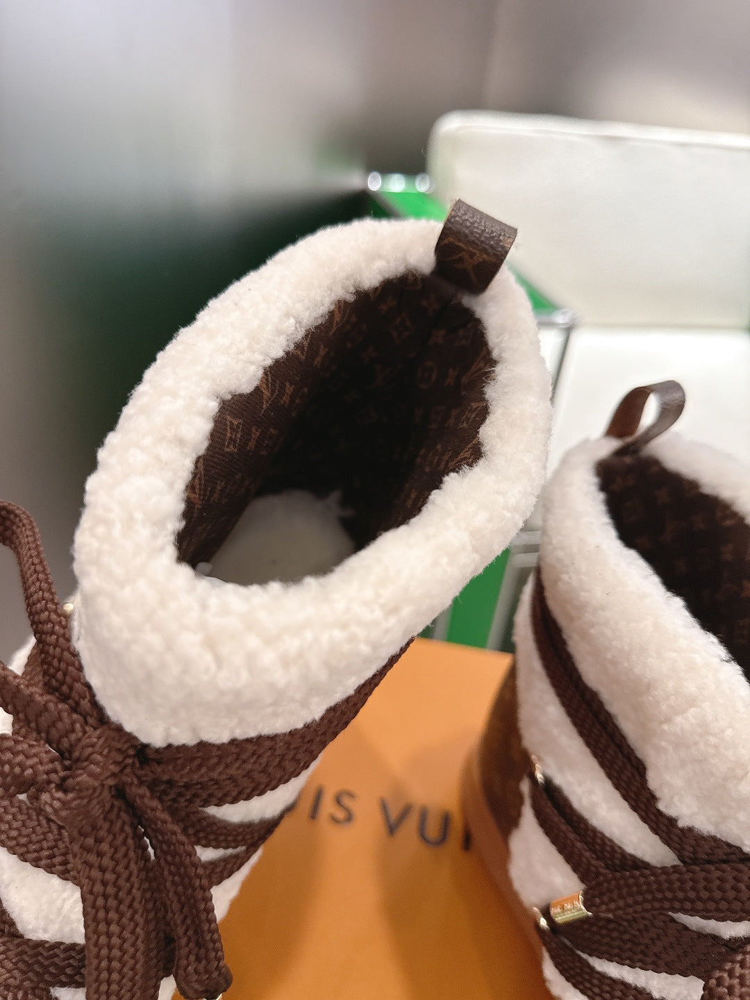 Louis Vuitton high-top sneaker interior detail with white fleece lining and brown upper