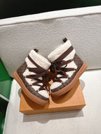 Louis Vuitton high-top sneakers close-up: brown monogram laces and white sherpa cuffs