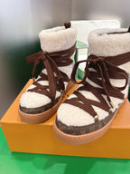 Louis Vuitton high-top sneakers on box, brown lace-up uppers with white fleece cuffs