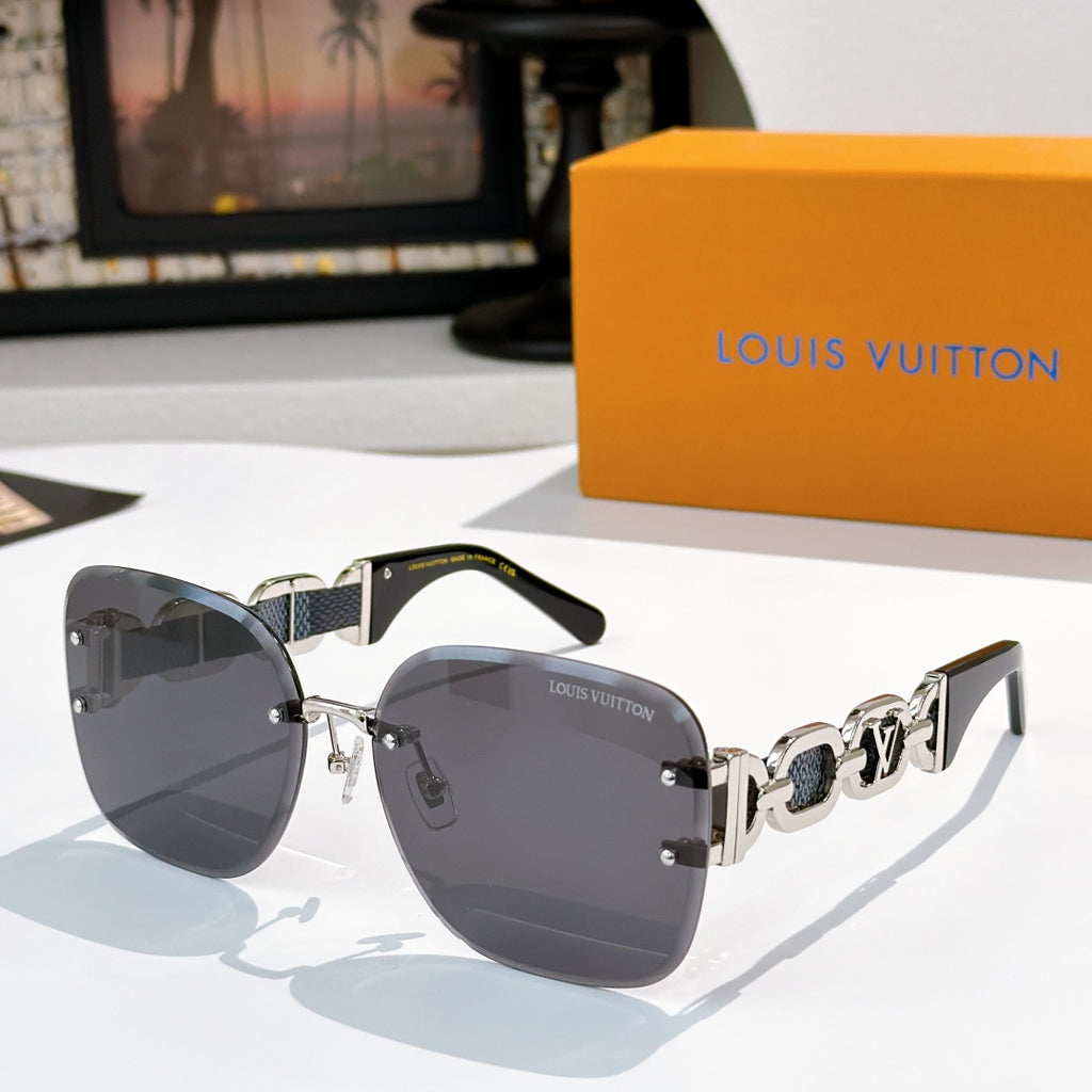 Sunglasses with dark gray lenses, black frame, and metallic patterned temple bars