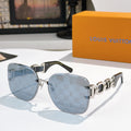Sunglasses with light blue lenses, dark frame, and patterned temple bars