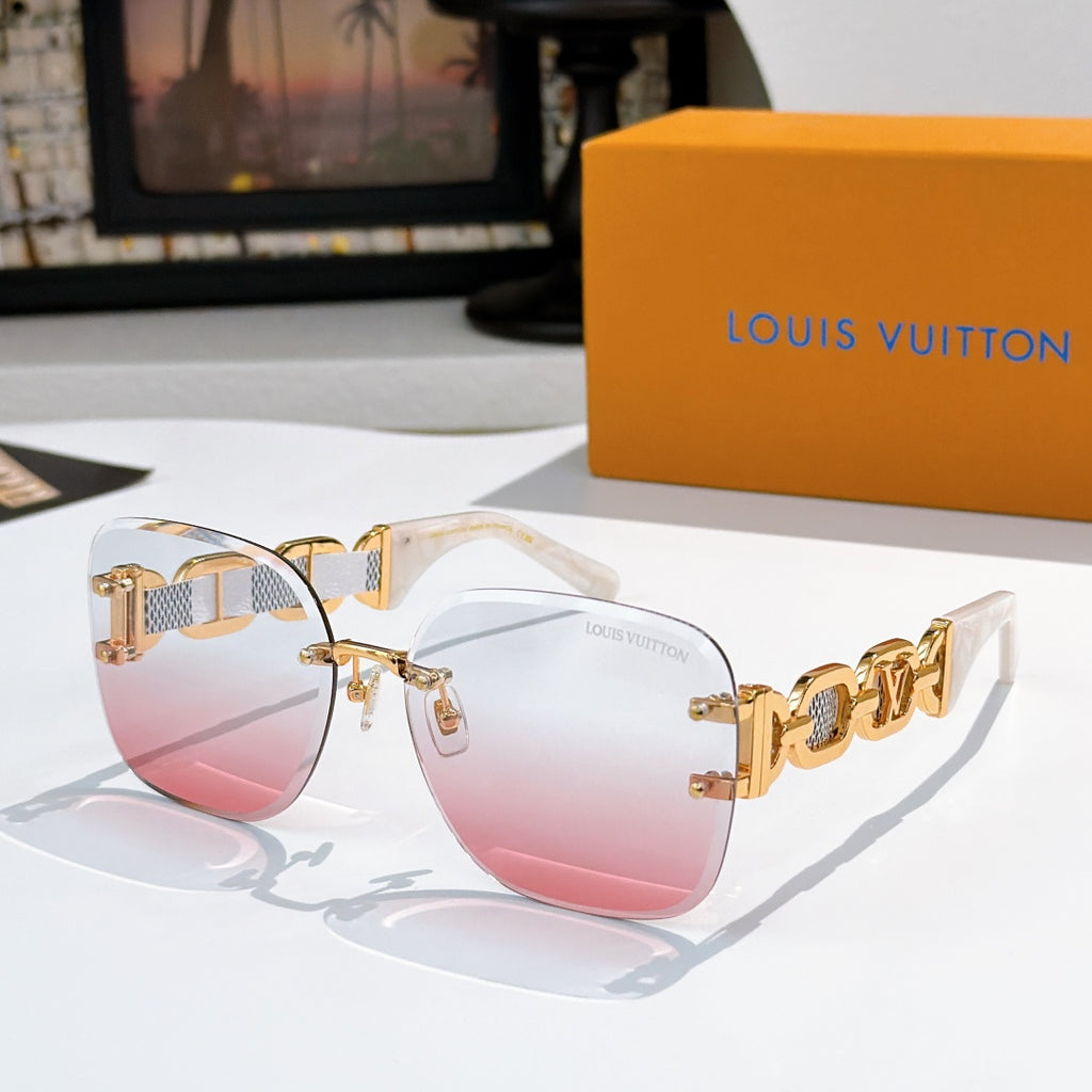 Sunglasses with pink gradient lenses, translucent frame, and gold patterned temples