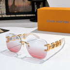 Sunglasses with pink gradient lenses, translucent frame, and gold patterned temples