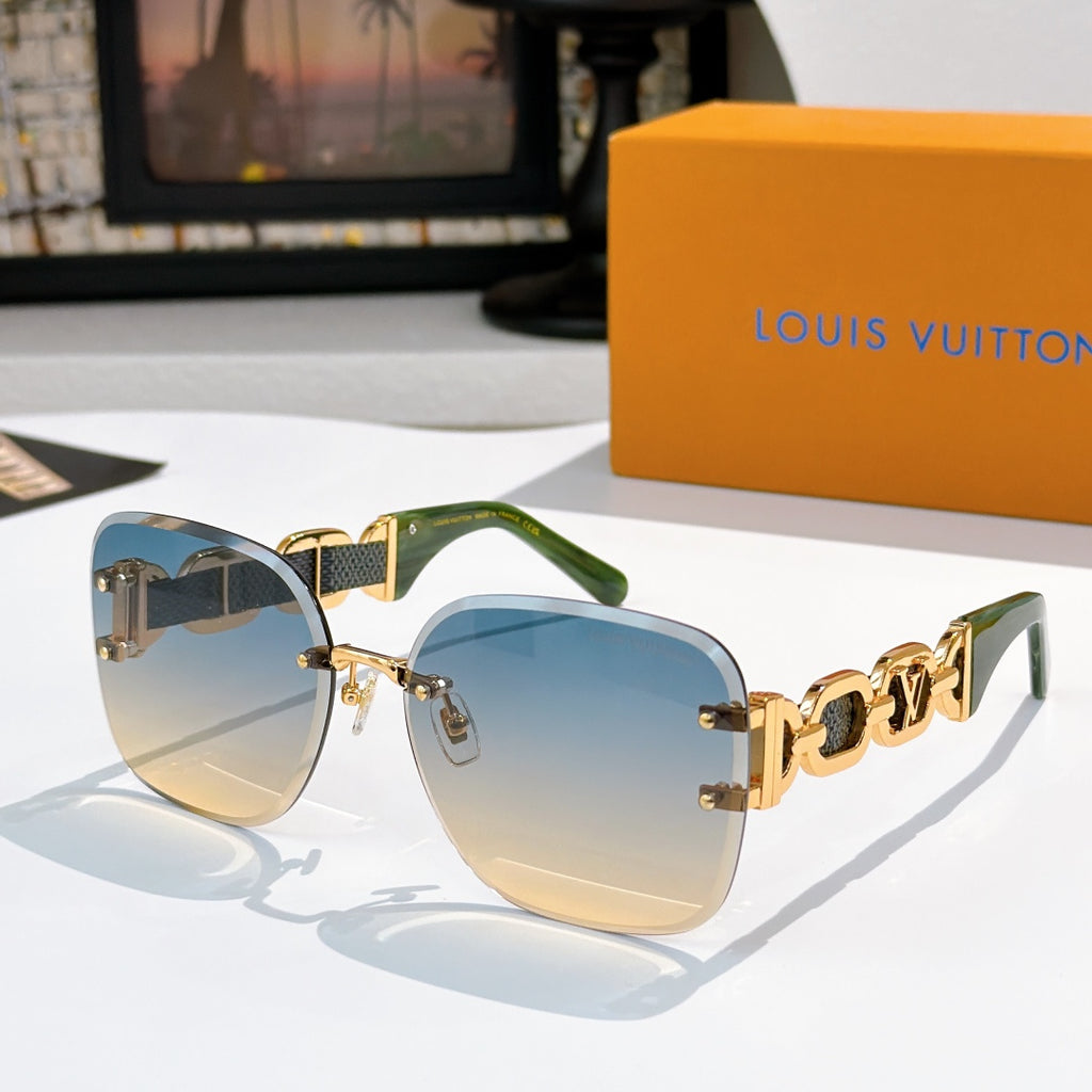 Sunglasses with blue-tinted lenses, gold frame, and green-accent patterned temples