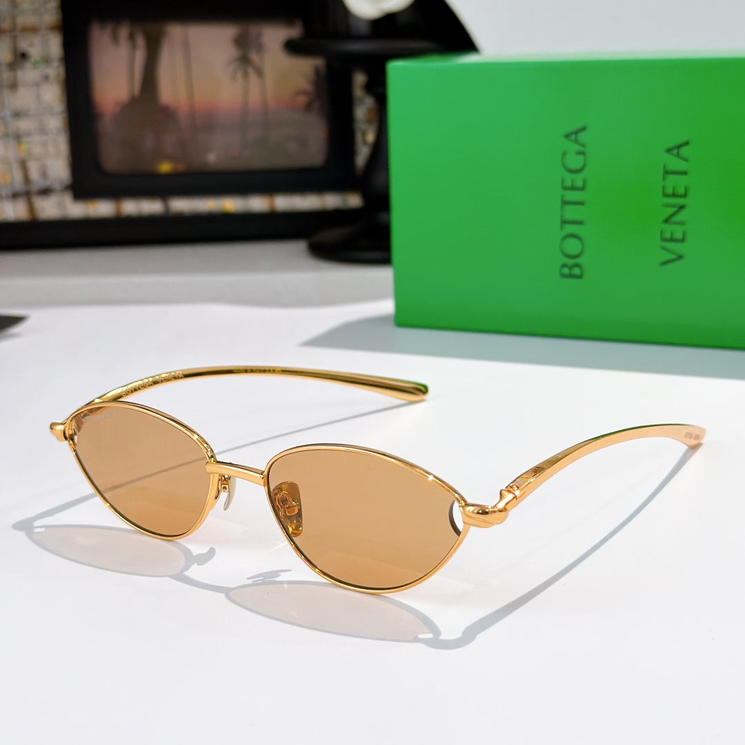 Bottega Veneta sunglasses with gold frame and light tan oval lenses