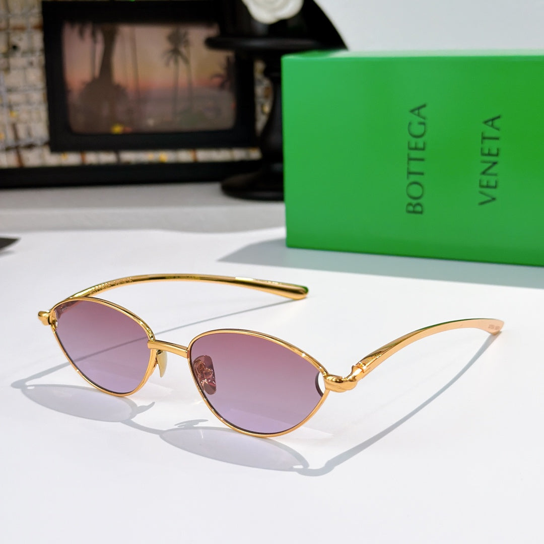 Bottega Veneta sunglasses with gold frame and pink tinted oval lenses