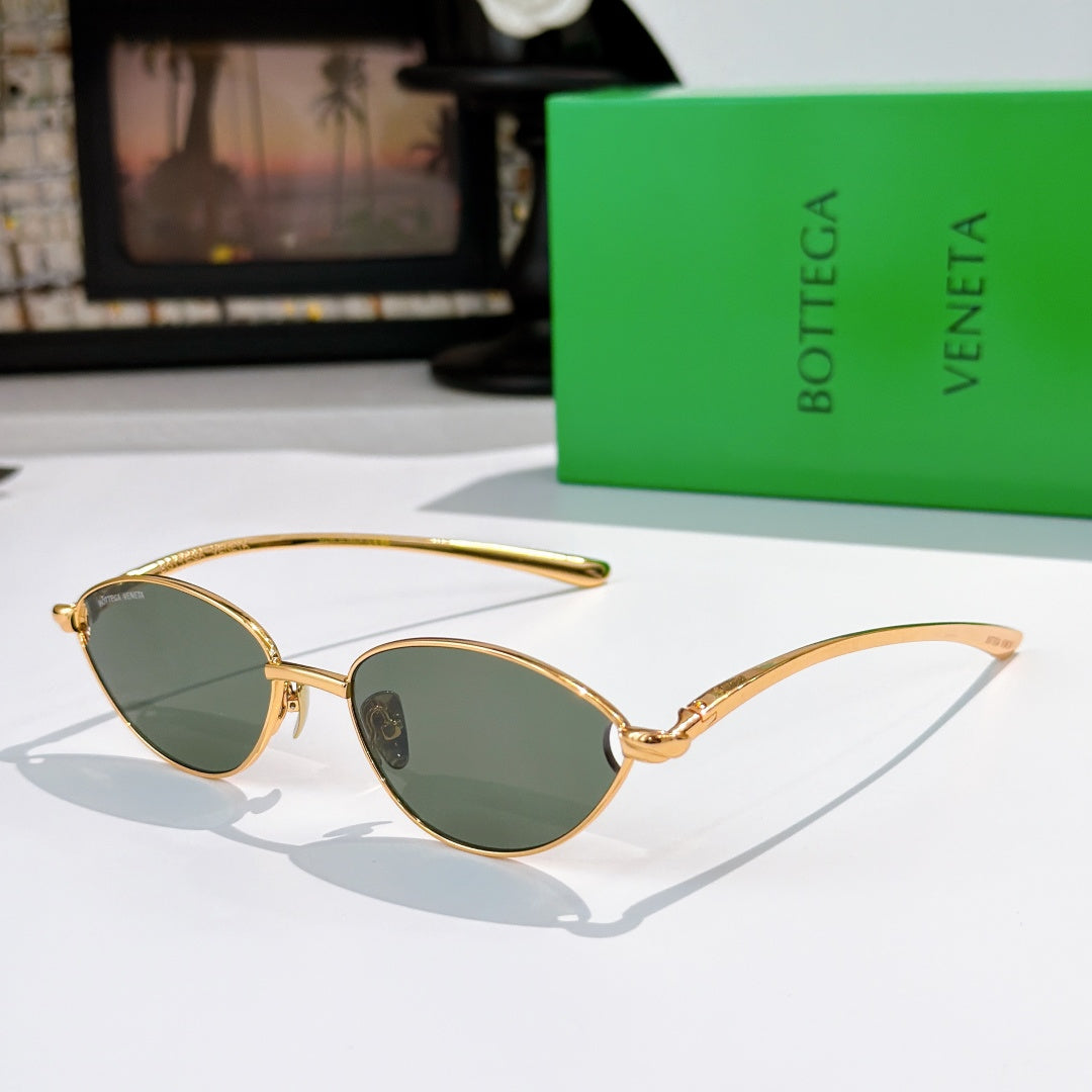 Bottega Veneta sunglasses with gold frame and green tinted oval lenses