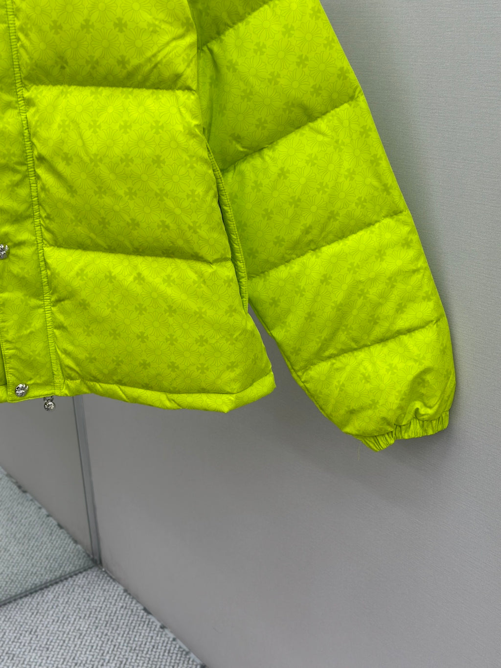 Neon green puffer jacket sleeve and hem with quilted padding and elastic cuff