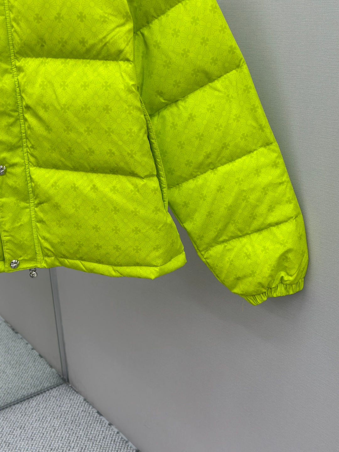 Neon green puffer jacket sleeve and hem with quilted padding and elastic cuff