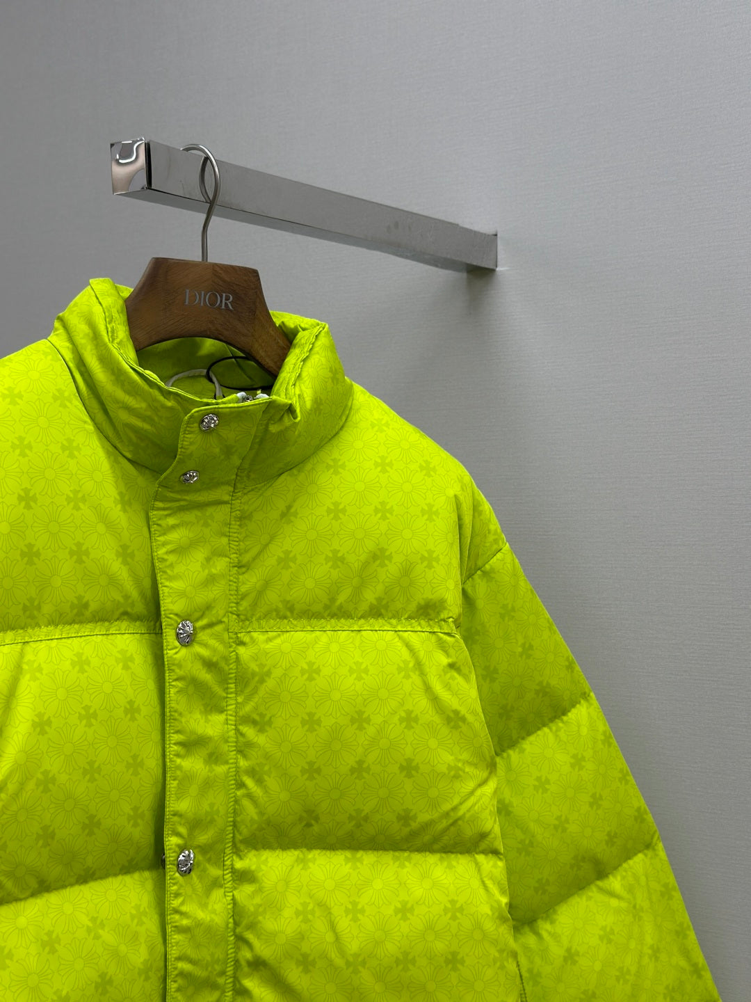Neon green puffer jacket with button-front and wide horizontal quilted panels