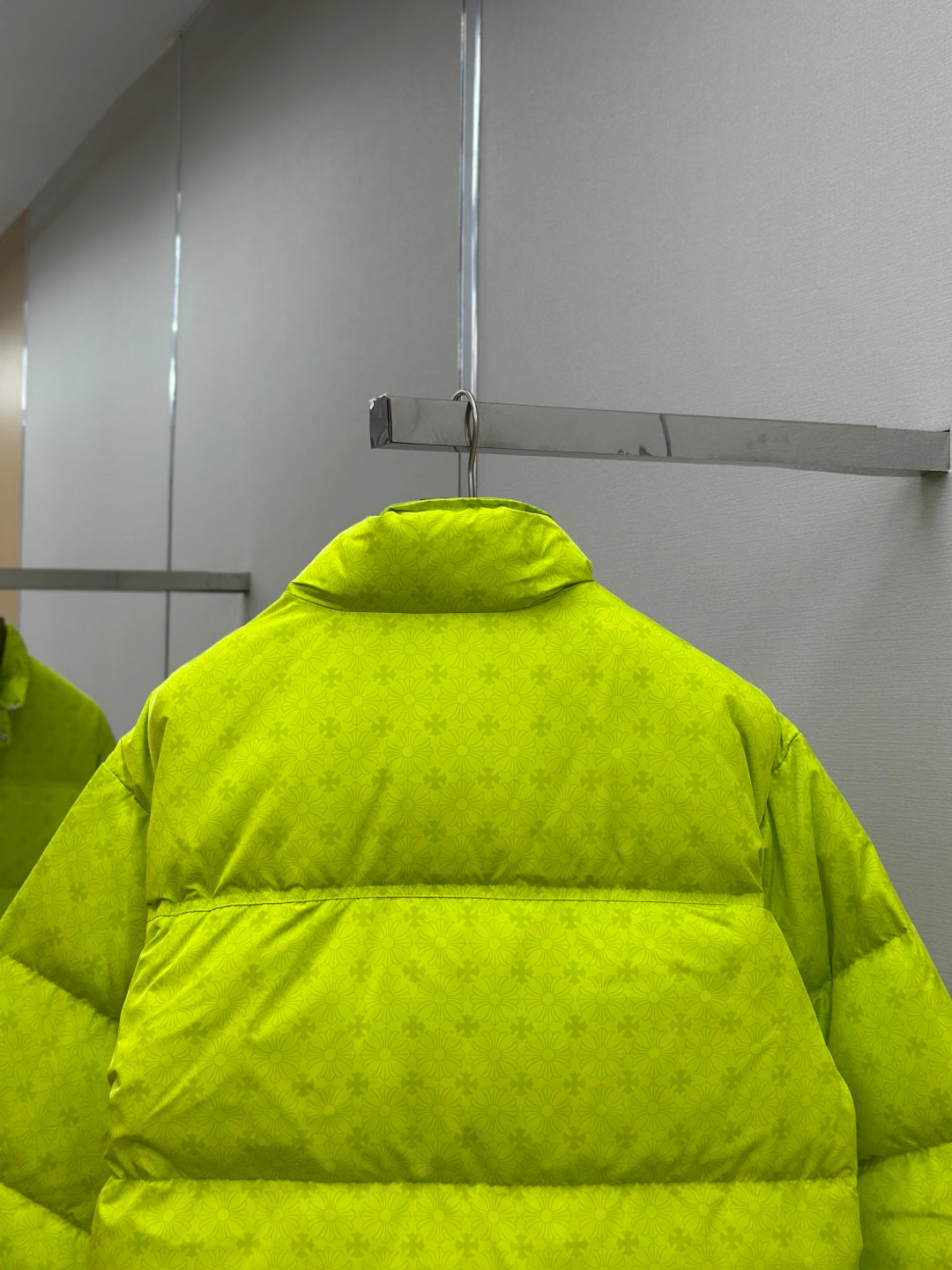 Back of long neon green puffer jacket with high collar and horizontal quilting