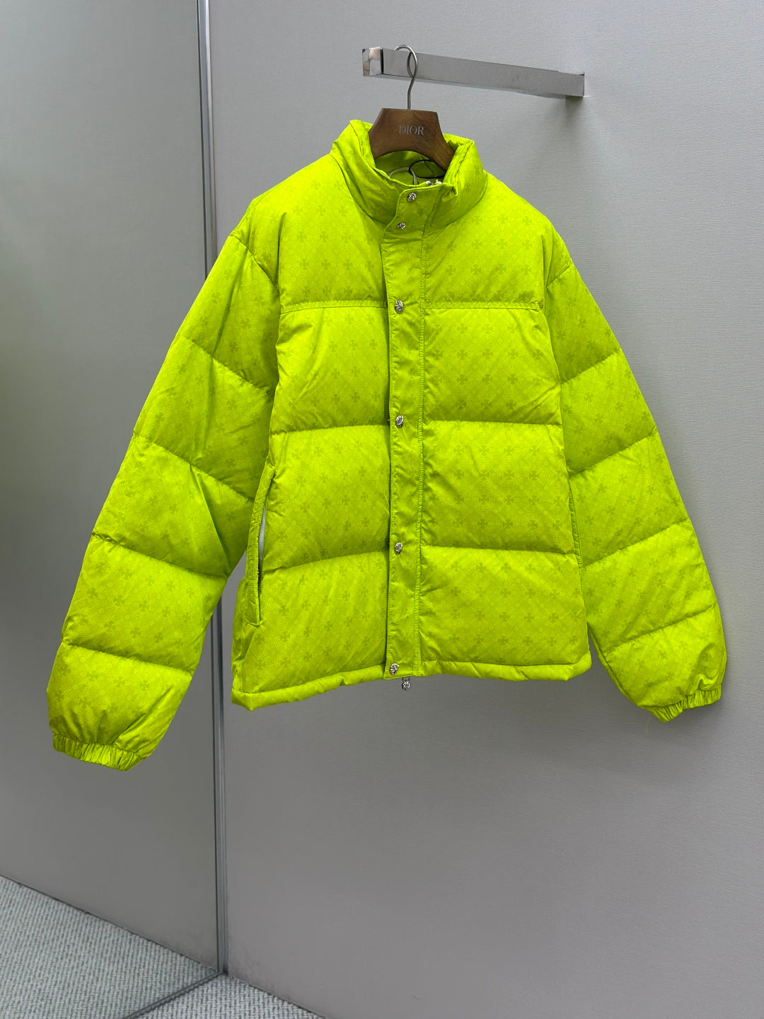 Long neon green puffer jacket with button-front, stand collar, and ribbed cuffs