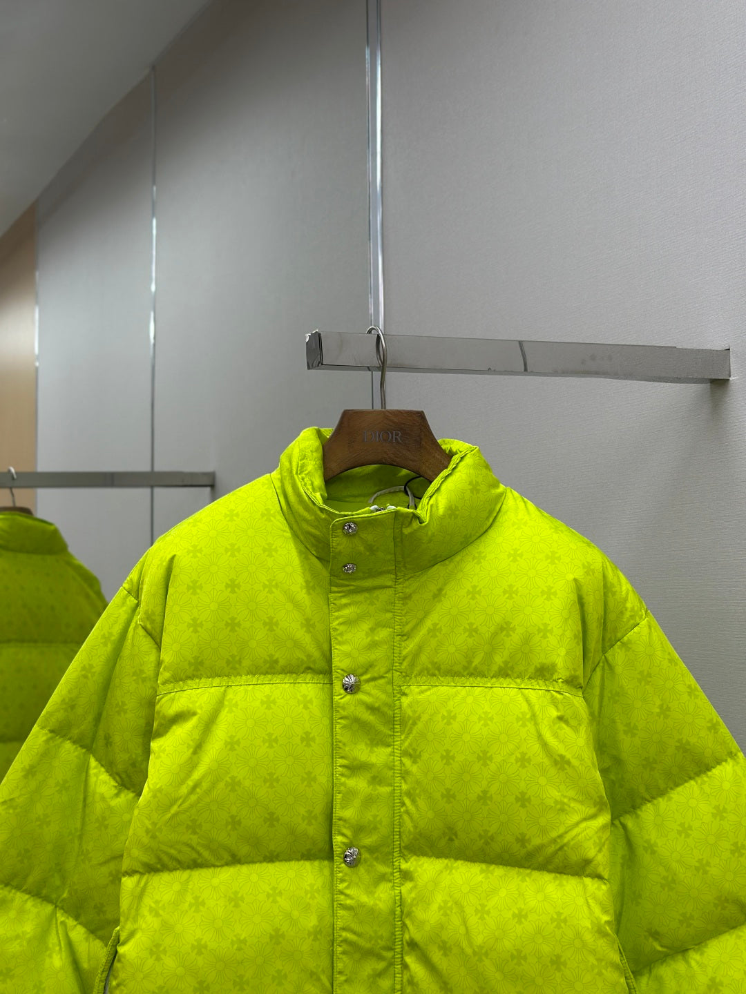 Neon green puffer jacket with button placket and textured stand collar
