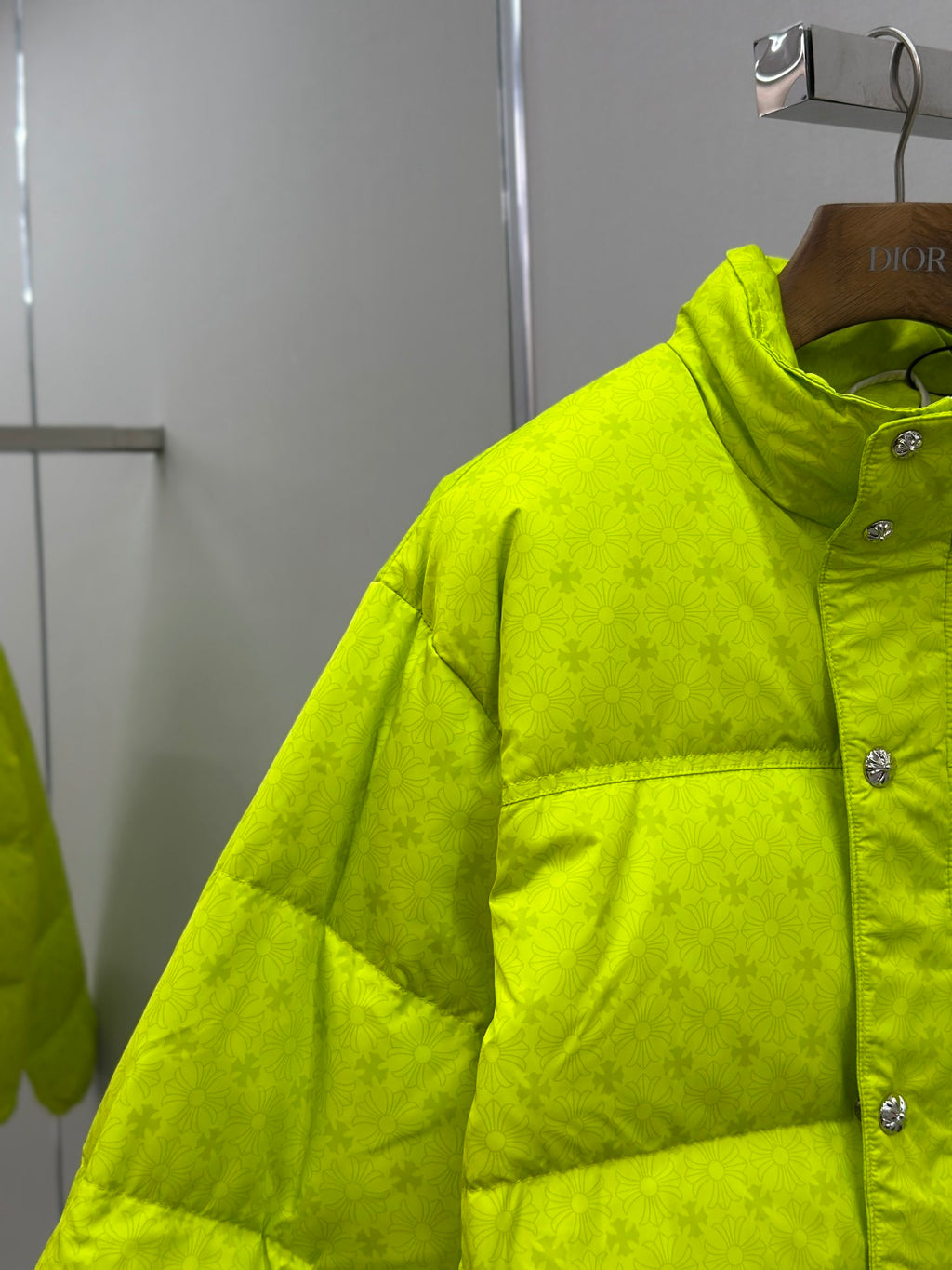 Neon green puffer jacket with color-block quilting and button placket