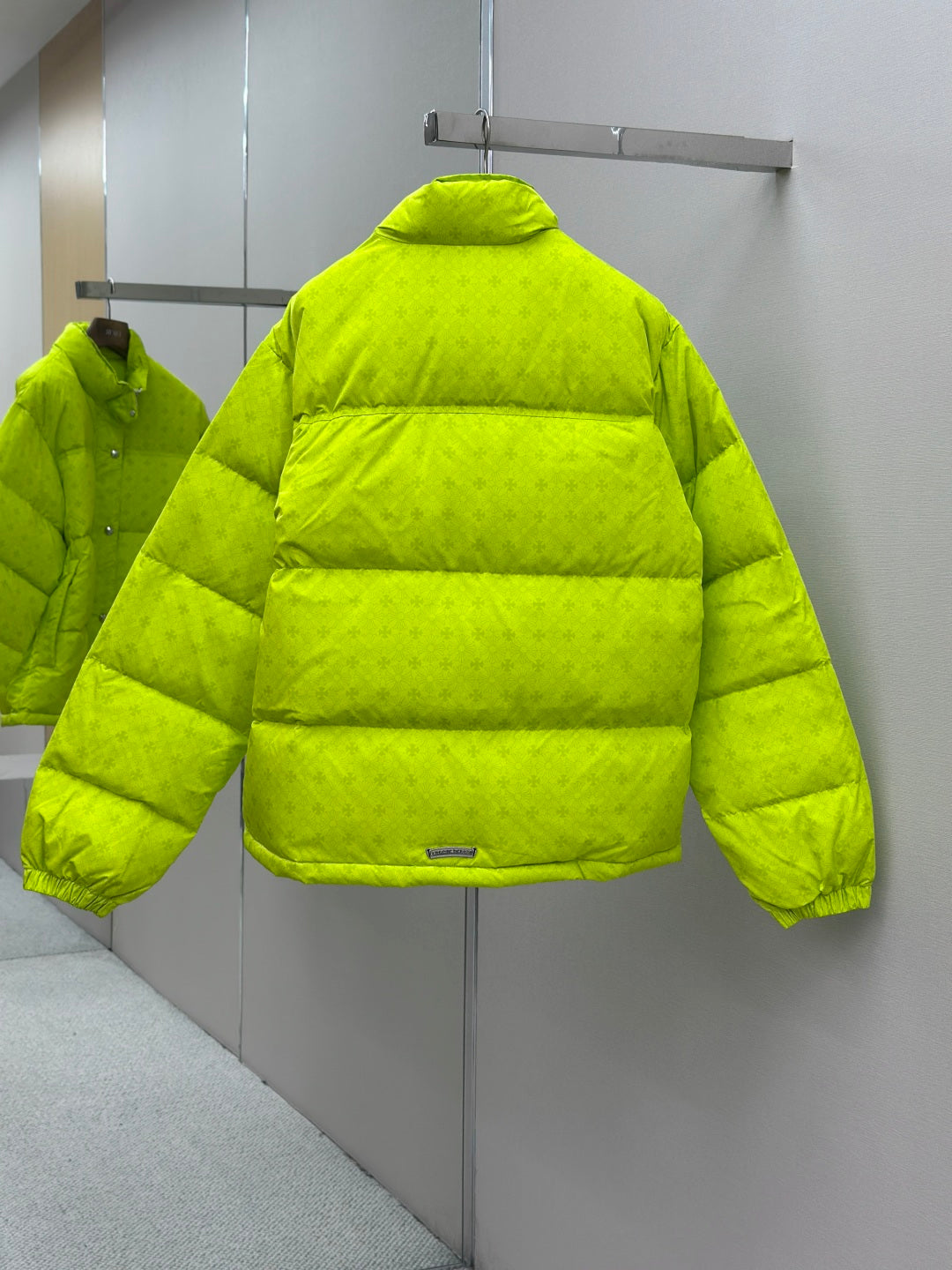 Long neon green puffer jacket with horizontal quilting and high collar