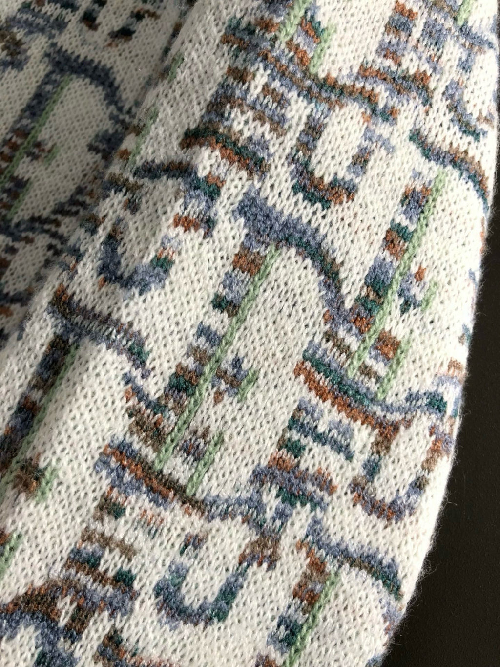Dior knit sweater fabric detail, cream knit with blue multicolor motif
