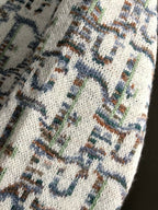 Dior knit sweater fabric detail, cream knit with blue multicolor motif