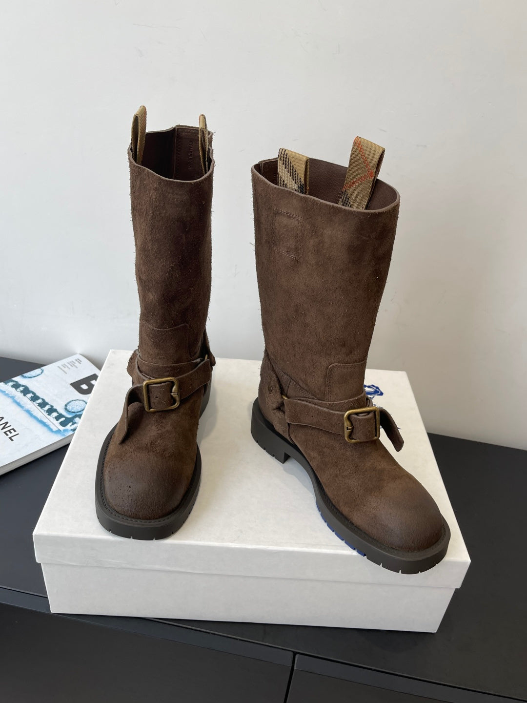 Burberry dark brown suede knee-high boots, side view with buckle strap and tread sole