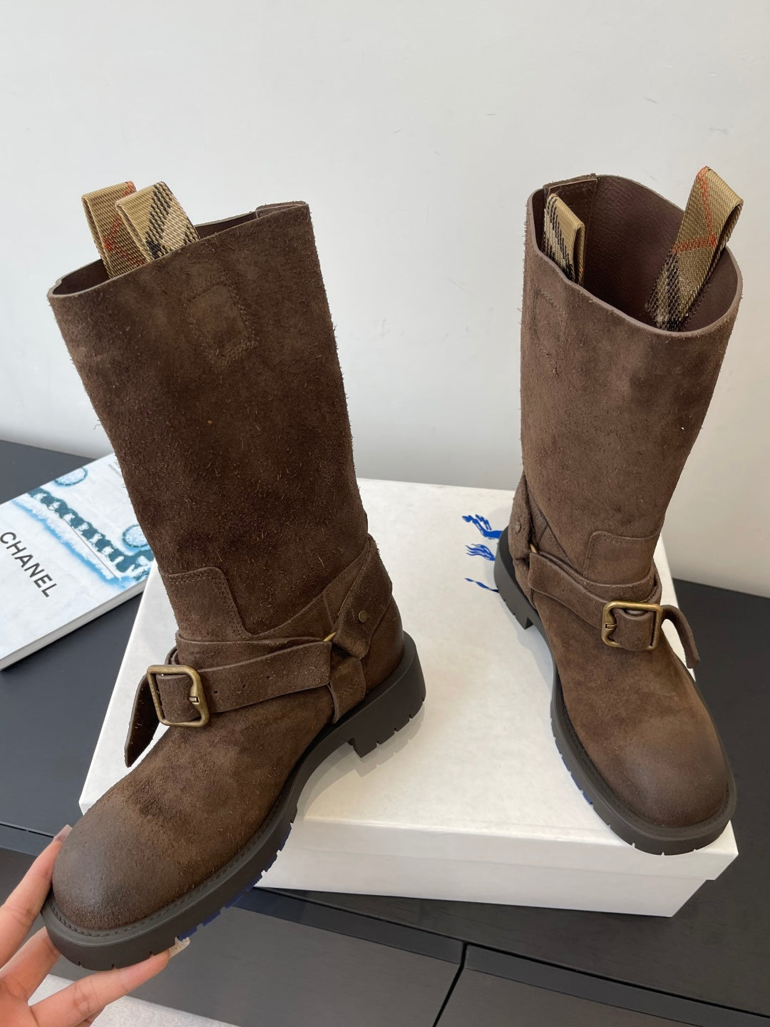 Burberry dark brown suede knee-high boots, angled view with buckle strap detail