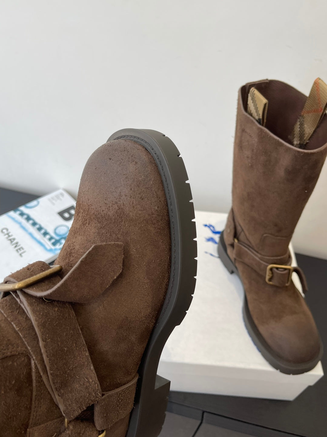 Burberry dark brown suede boots with buckle strap, close-up side view