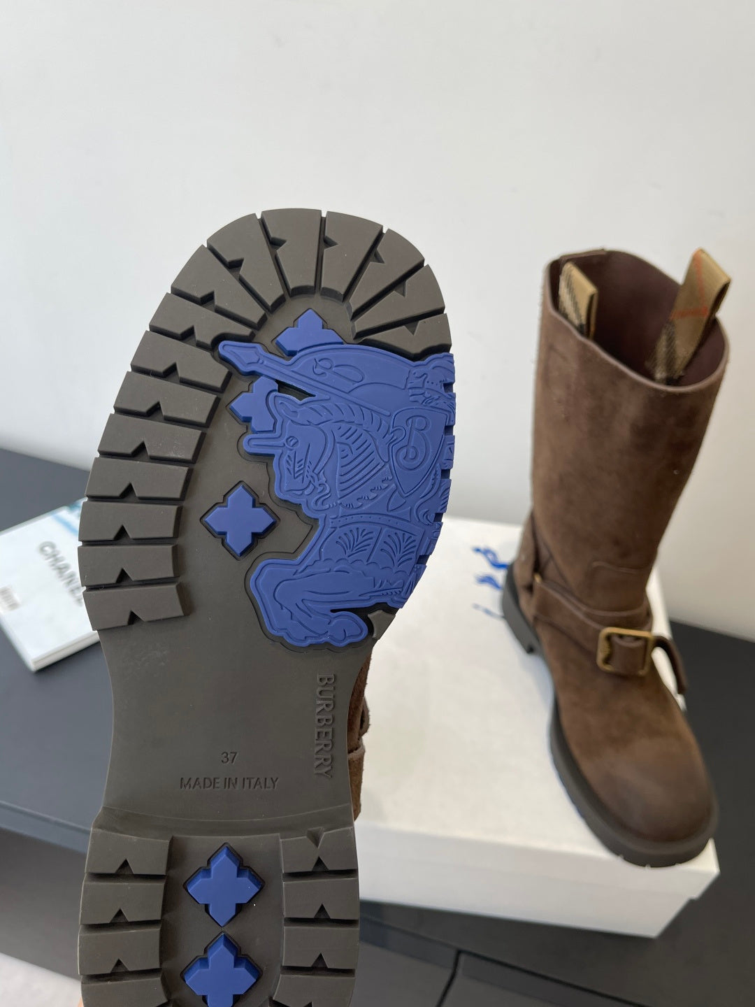 Burberry boot outsole view with textured tread and blue logo detail