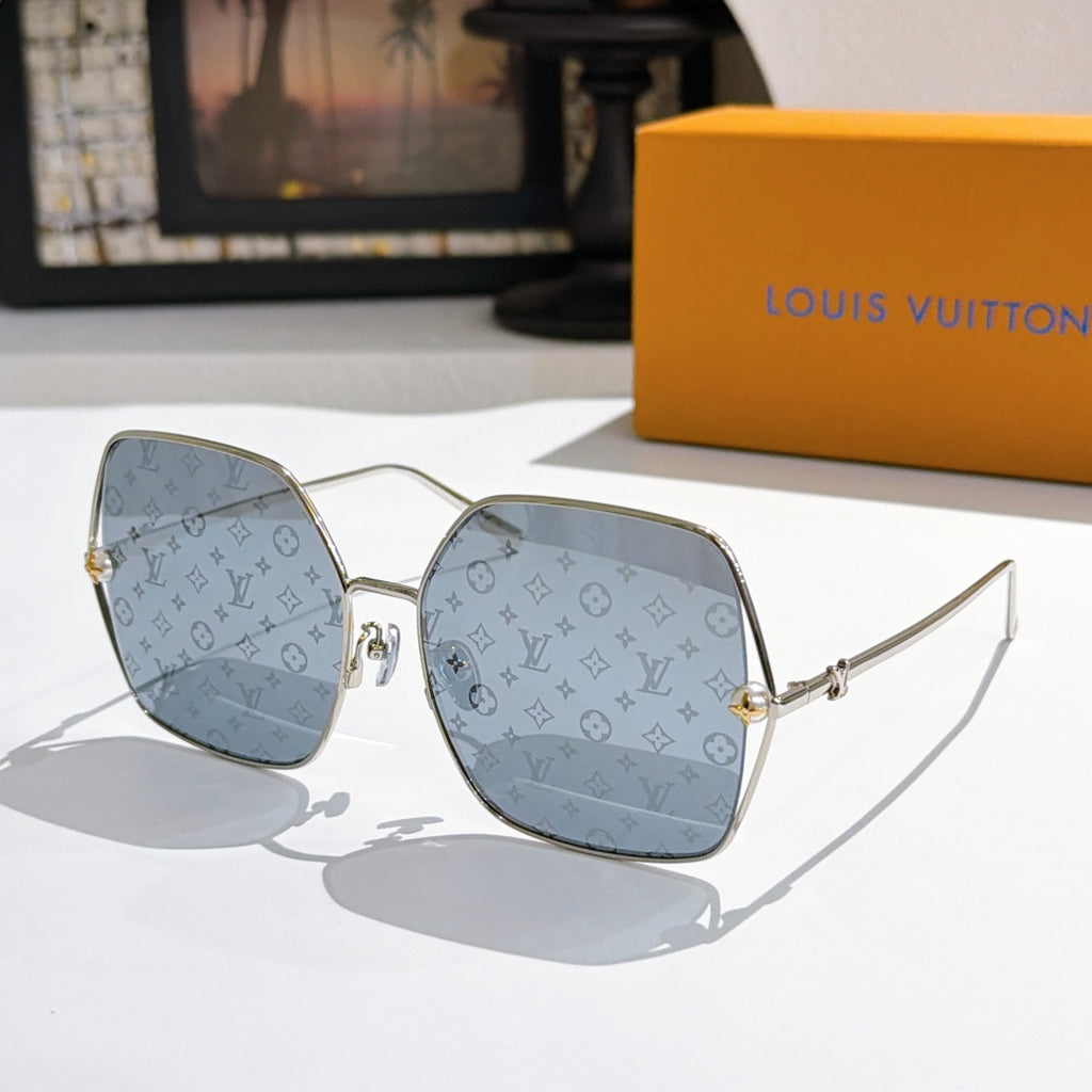 Louis Vuitton sunglasses with gold frames and medium blue gradient lenses