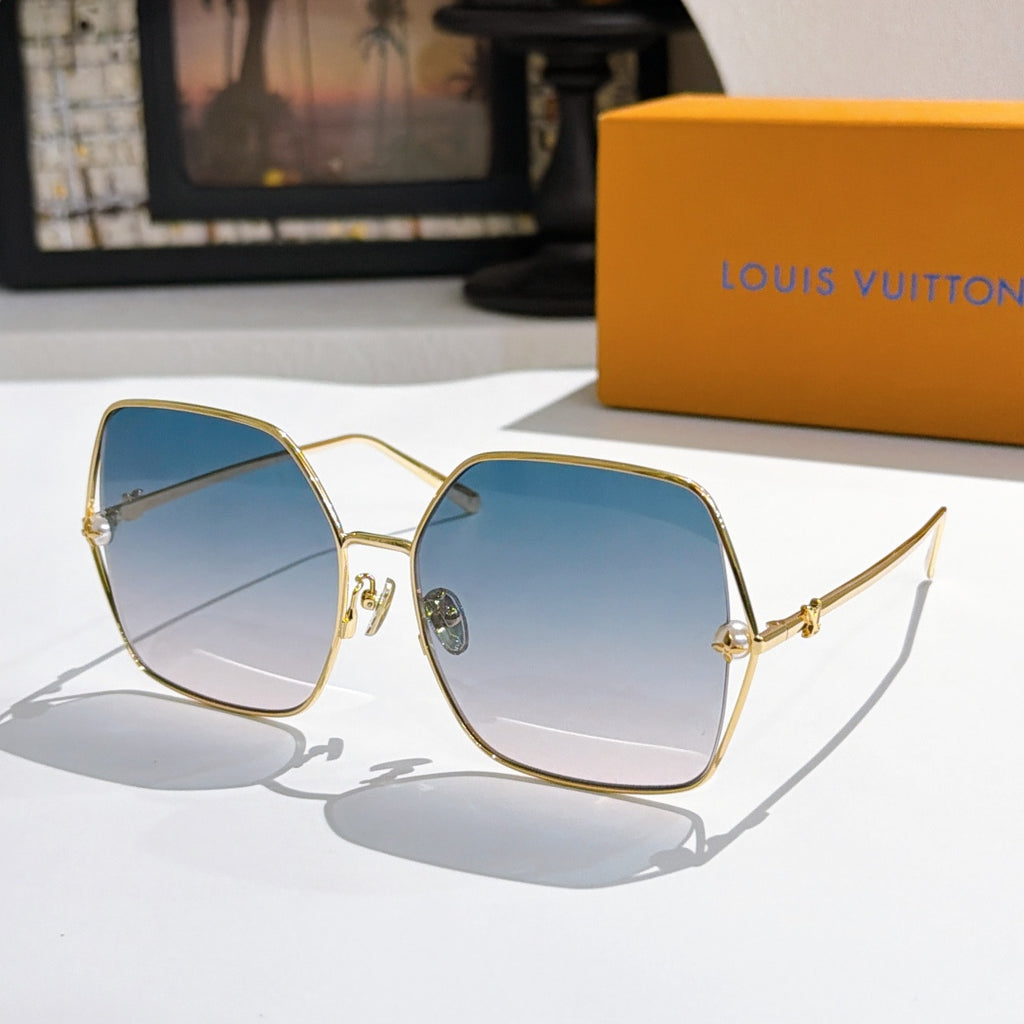 Louis Vuitton sunglasses with gold frames and pale blue gradient lenses