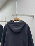 Dark blue hoodie back view with hood and embroidered logo, on hanger