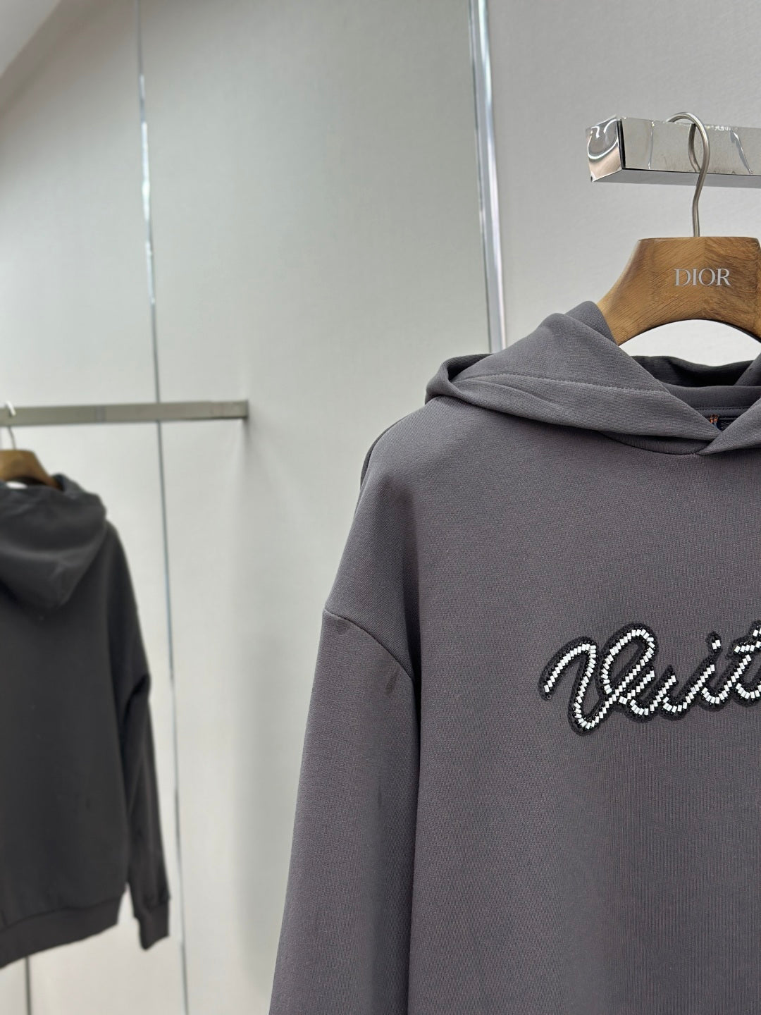 Dark gray hoodie sleeve and chest with Louis Vuitton logo, hooded sweatshirt