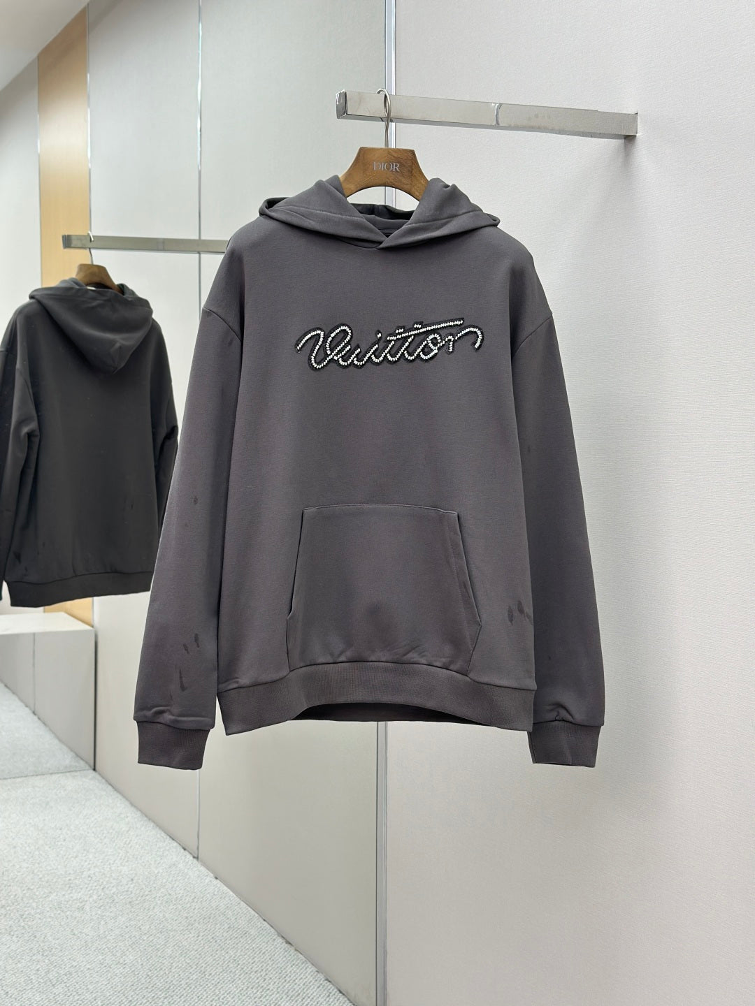Long-sleeve hoodie with hood, front pocket, and Louis Vuitton logo, dark gray