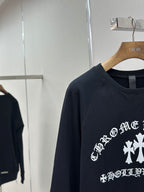Navy crewneck sweatshirt close-up of sleeve seam and partial front graphic