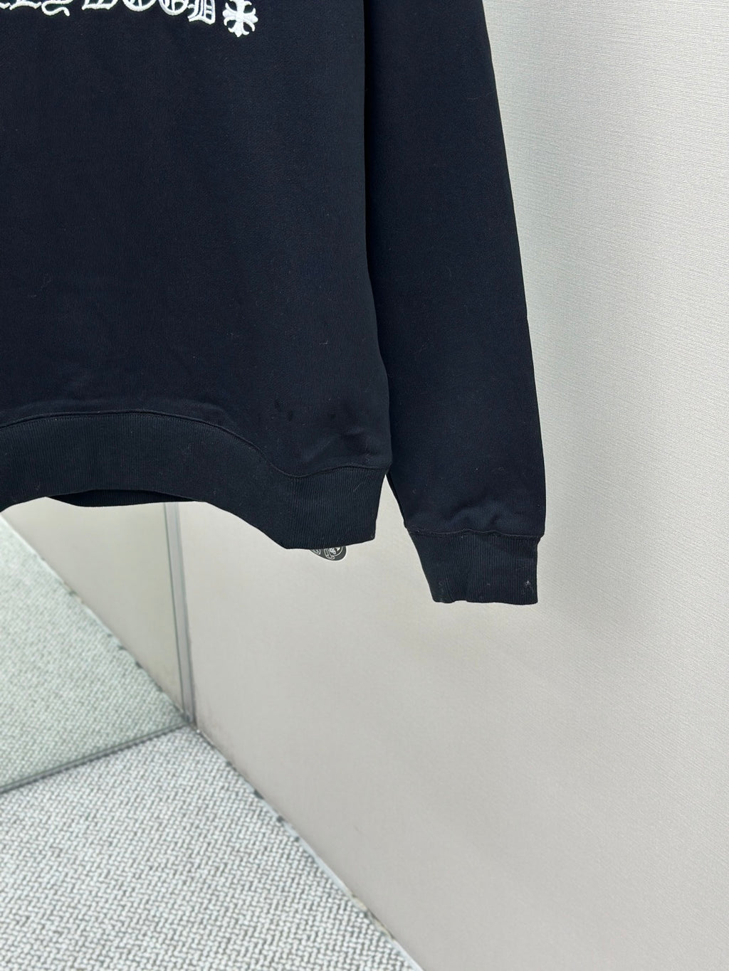 Navy crewneck sweatshirt cuffs and hem detail