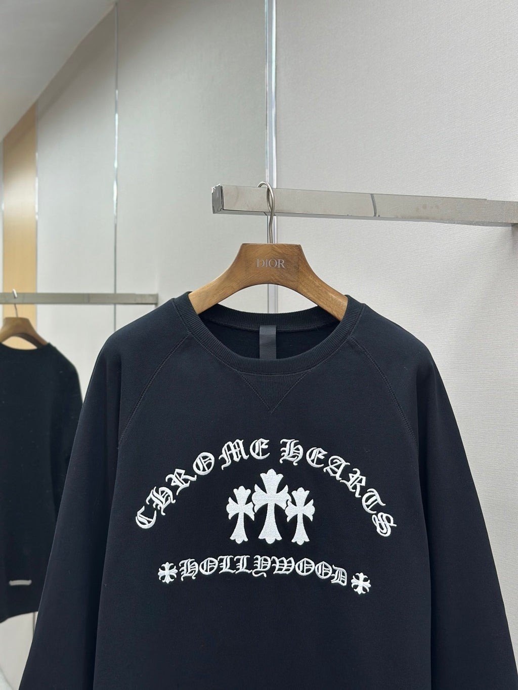 Navy crewneck sweatshirt close-up of white front graphic and text