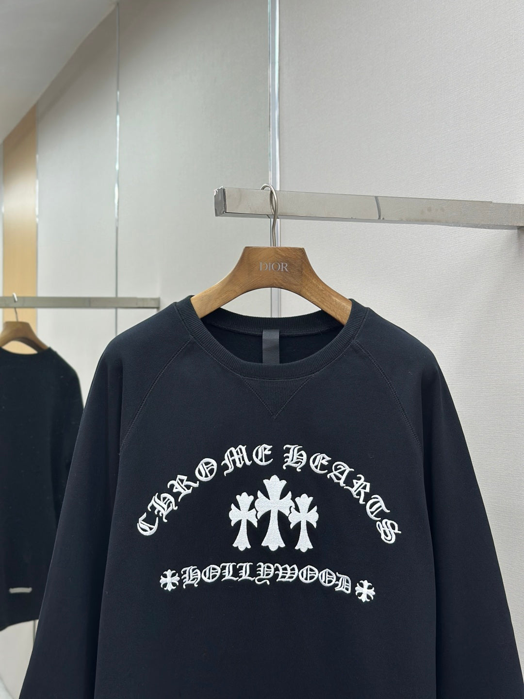 Navy crewneck sweatshirt close-up of white front graphic and text