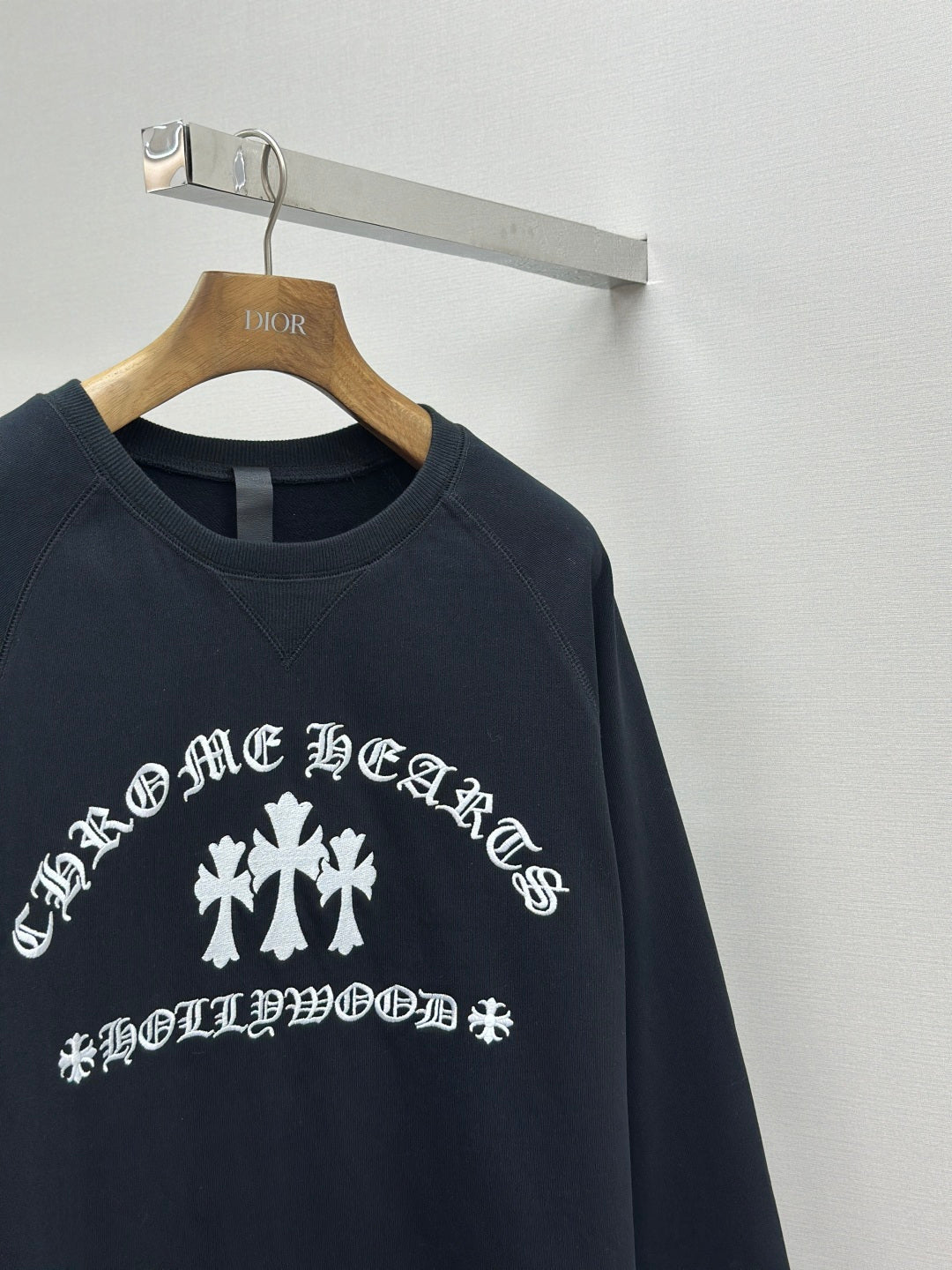 Navy crewneck sweatshirt with centered white cross emblem print