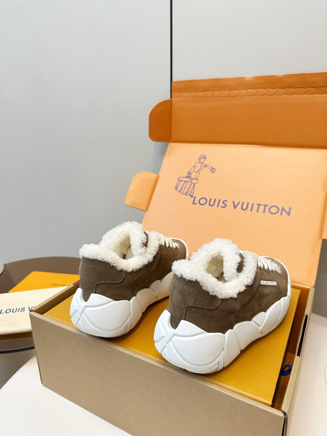Brown high-top sneakers with plush white lining and thick white sole