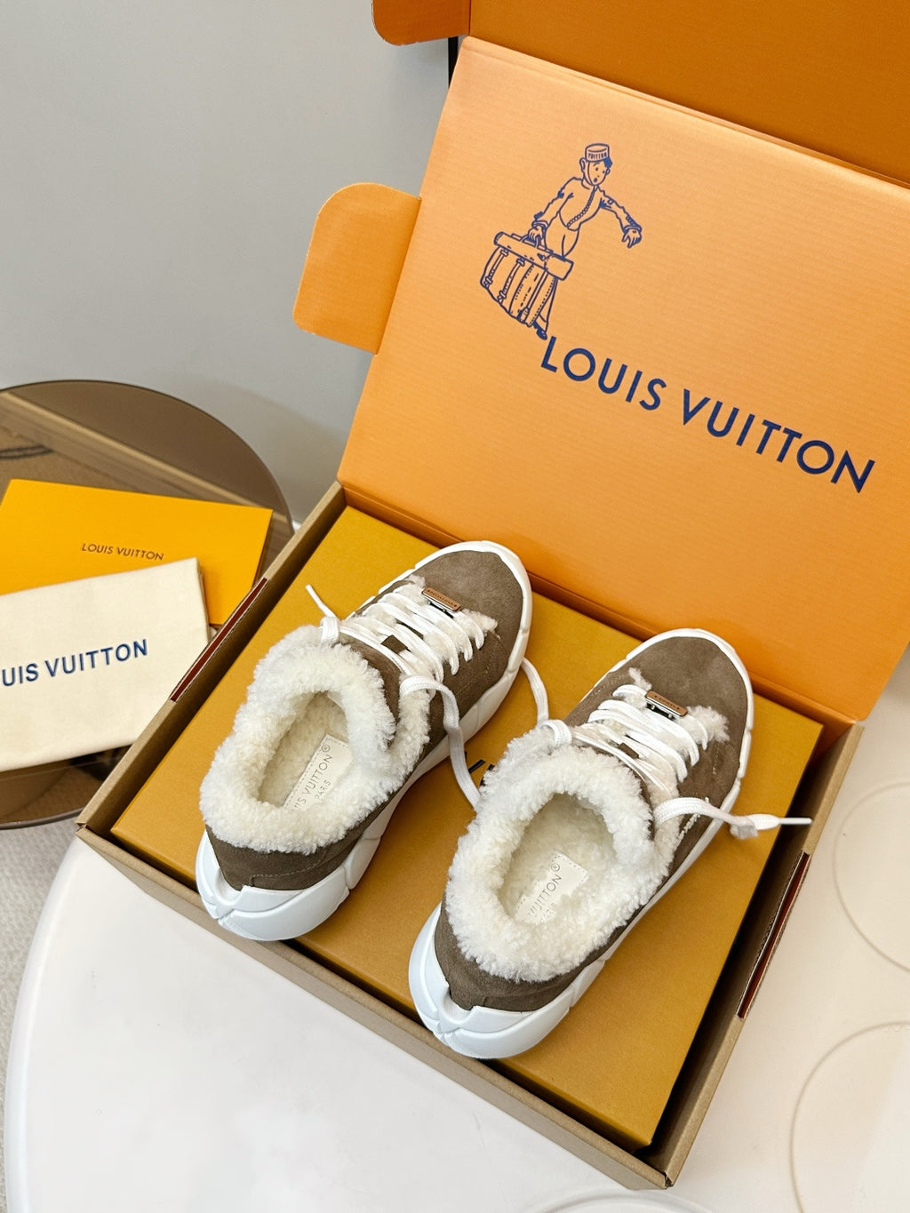 Brown lace-up sneakers with sherpa lining and white soles, shown side by side