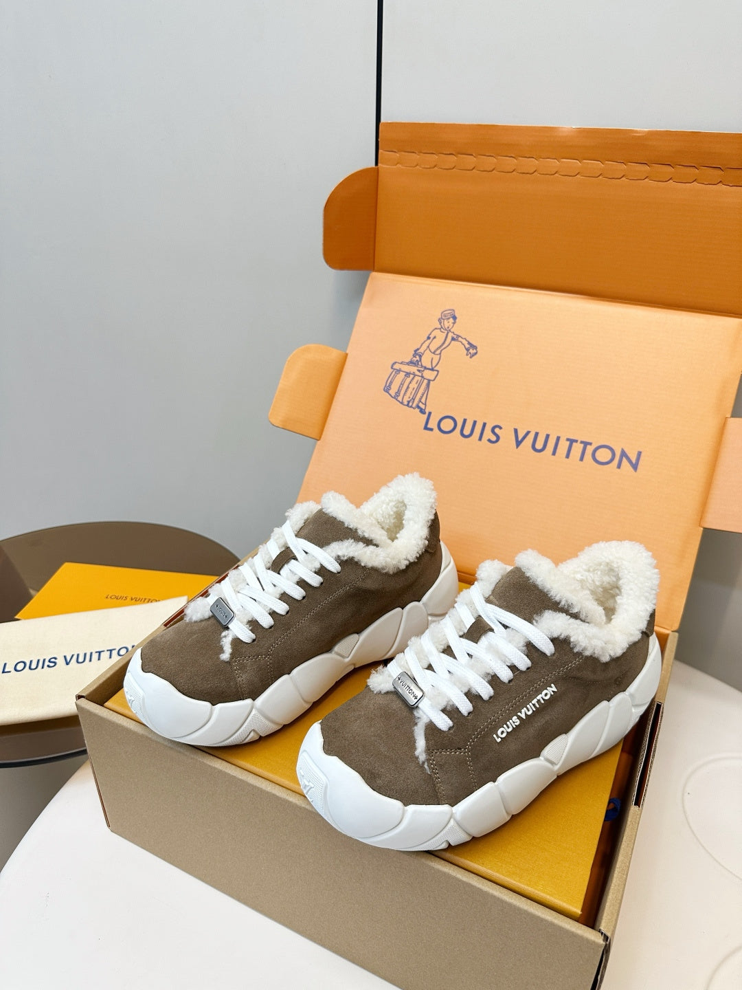 Brown high-top sneakers with plush white collar and white lace-up front