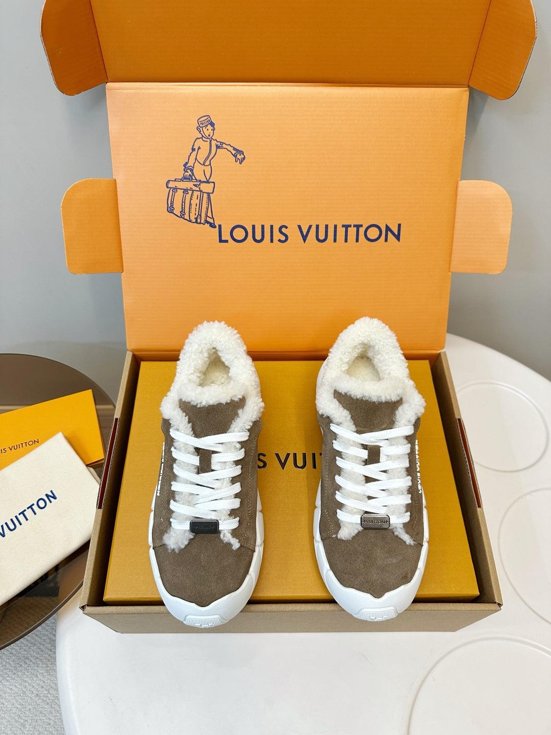 Brown-and-white sherpa-lined sneakers with white laces and chunky sole
