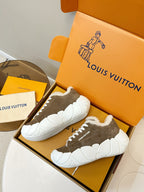 Pair of brown sneakers with white plush lining and chunky white soles