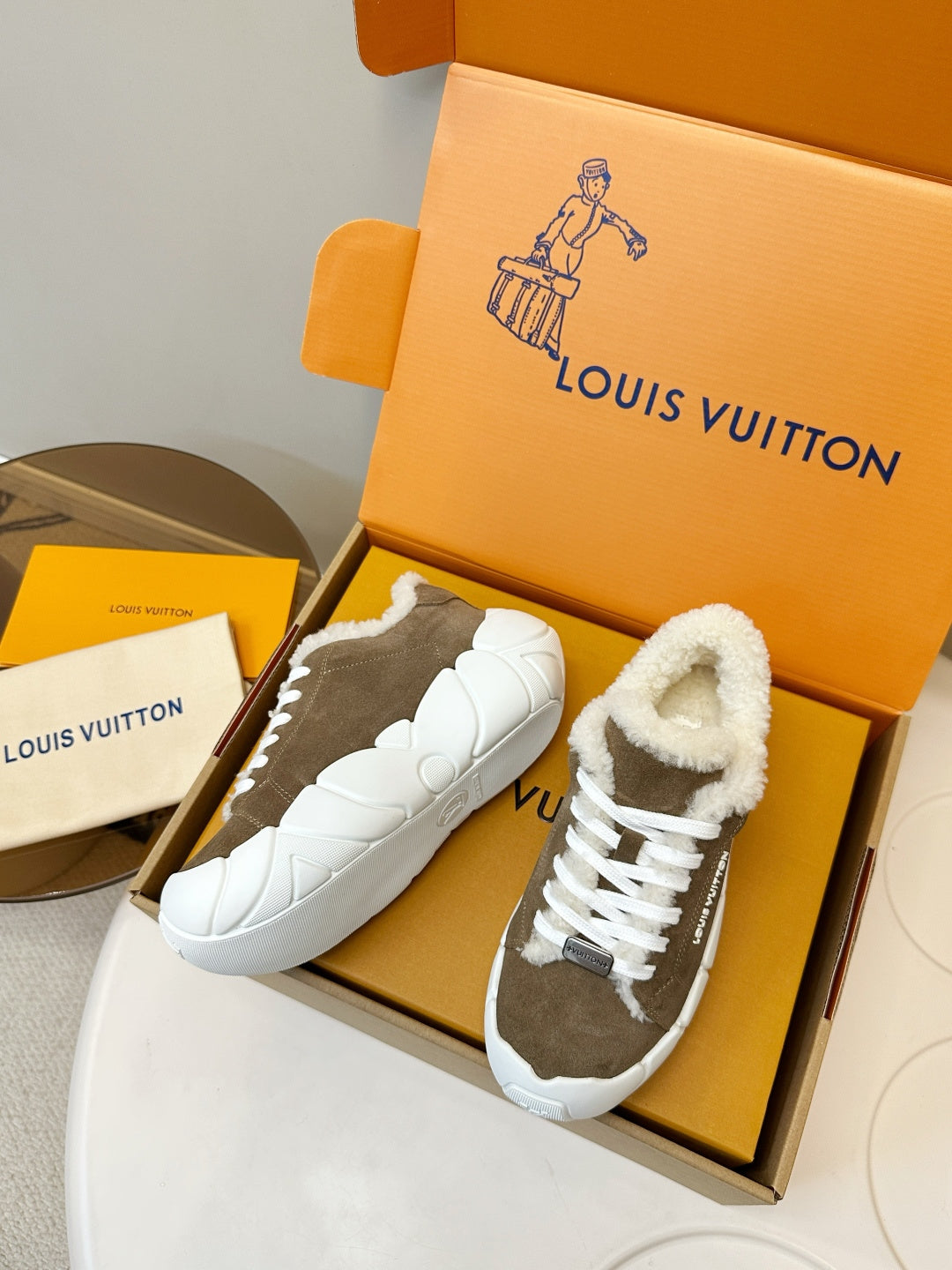 Brown slip-on sneakers with plush sherpa collar and white rubber sole